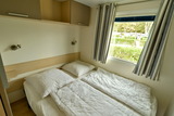 Ferienhaus in Pelzerhaken - Mobilheim M&eacute;diterran&eacute;e im Ferienpark AM WALDRAND - Schlafzimmer mit Doppelbett